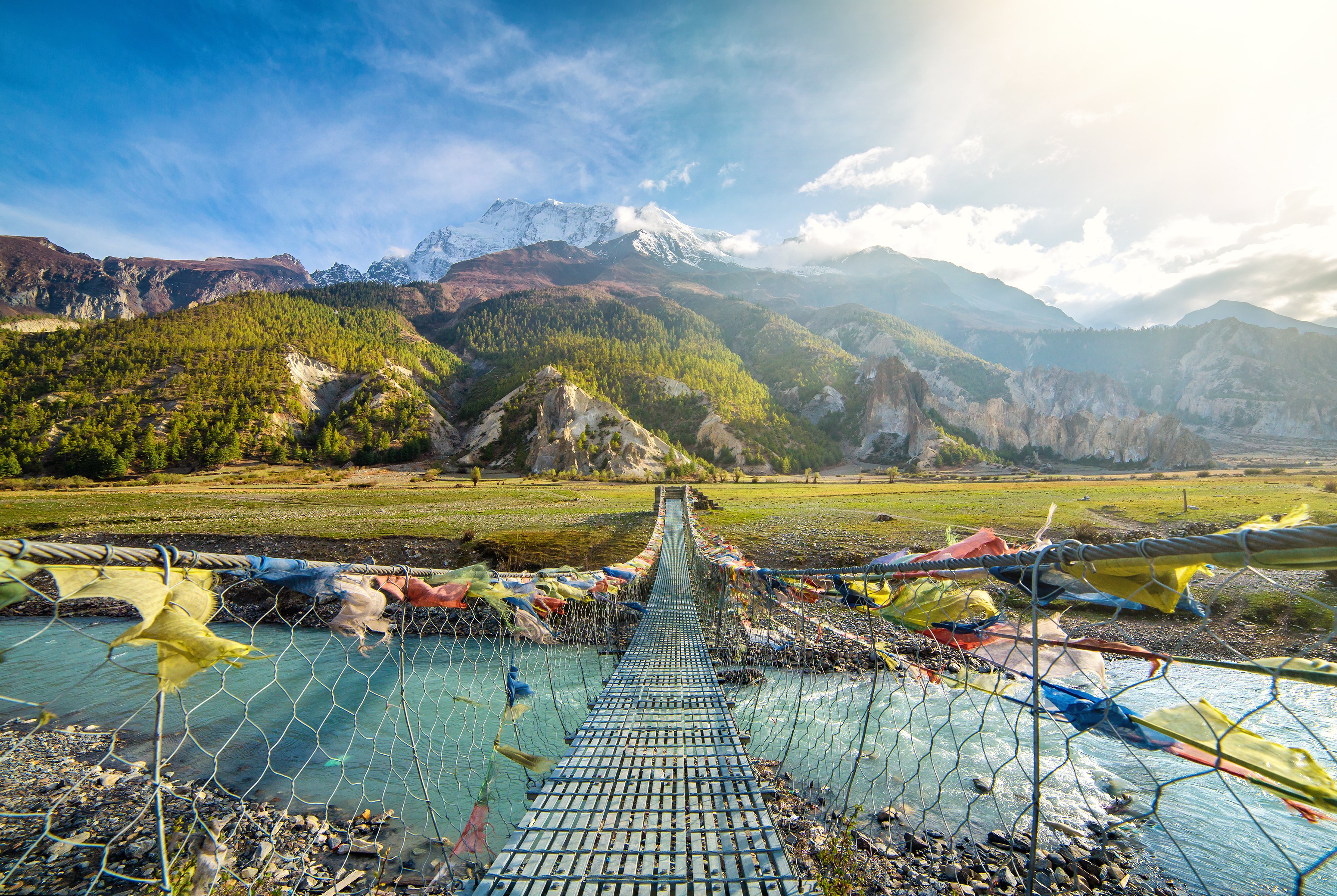 Suspension bridge with buddhist prayer flags AdobeStock_276163048-jpeg-1